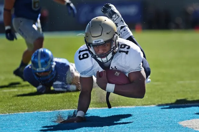 Predix Hackathon - Navy football player diving into the endzone for a touch down.